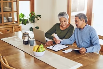 A couple reviewing their options together at a laptop